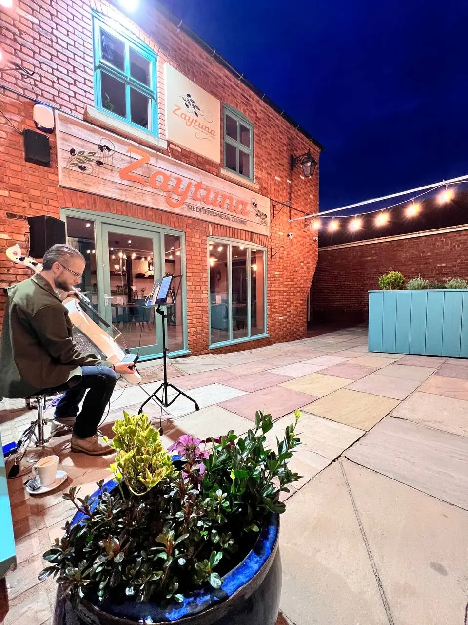 Musician outside restaurant's facade